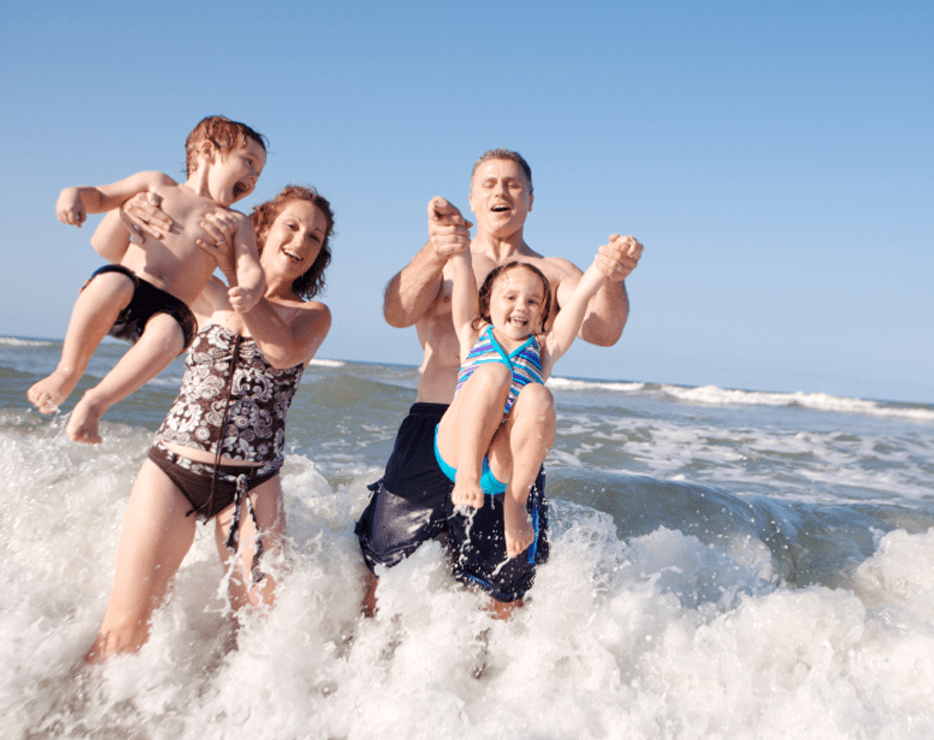 Family playing on the beach